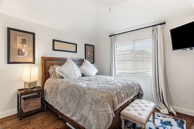 bedroom with dark hardwood / wood-style floors