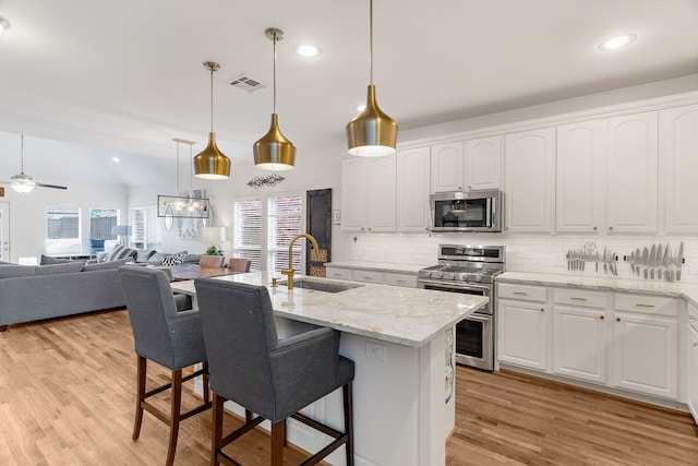 kitchen featuring ceiling fan, sink, white cabinets, and appliances with stainless steel finishes