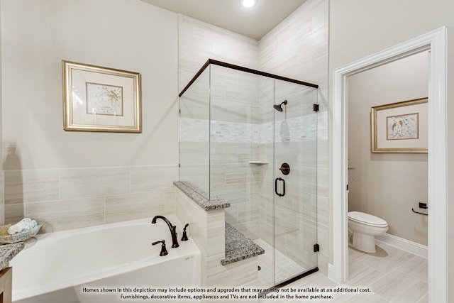 bathroom featuring shower with separate bathtub and toilet