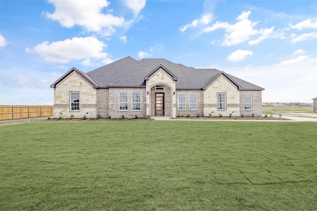 french provincial home with a front yard