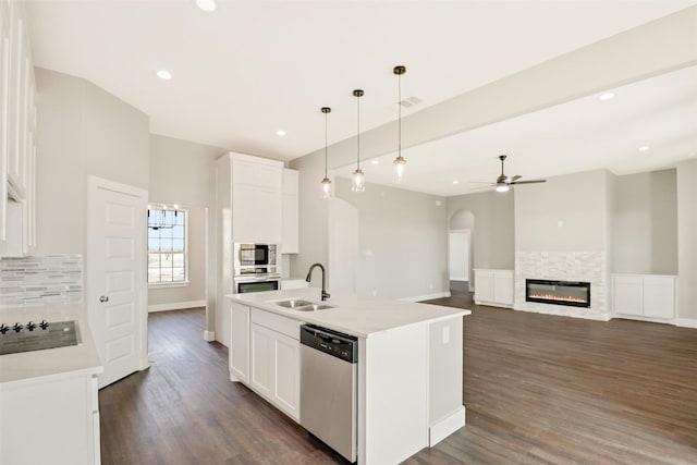 kitchen featuring white cabinetry, sink, an island with sink, pendant lighting, and appliances with stainless steel finishes