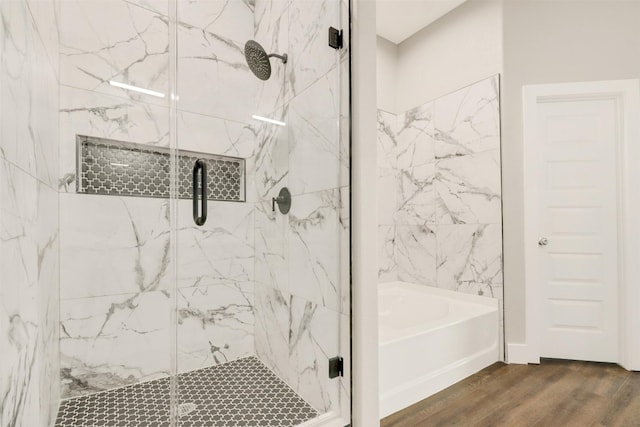 bathroom featuring hardwood / wood-style flooring and plus walk in shower