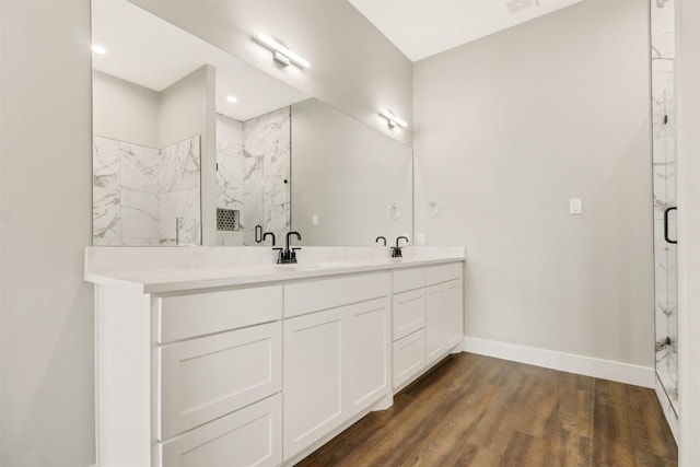 bathroom with vanity, a shower, and hardwood / wood-style floors