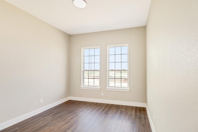 unfurnished room featuring dark hardwood / wood-style flooring