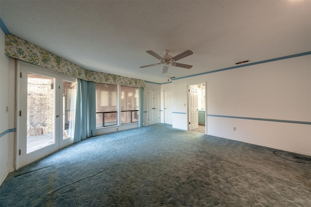 carpeted spare room with ceiling fan and french doors