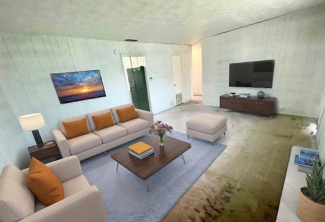 living room with wood walls and concrete flooring