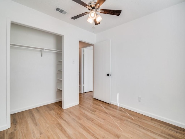 unfurnished bedroom with light wood-type flooring, a closet, and ceiling fan