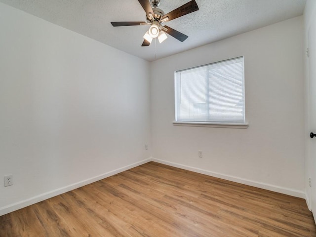 unfurnished room featuring ceiling fan, light hardwood / wood-style floors, and a textured ceiling