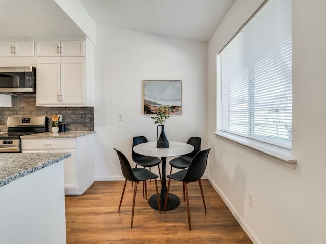 dining space with light hardwood / wood-style floors