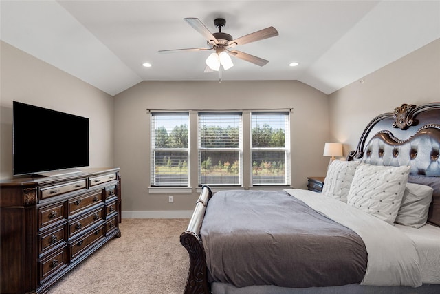 bedroom featuring light colored carpet, vaulted ceiling, and ceiling fan