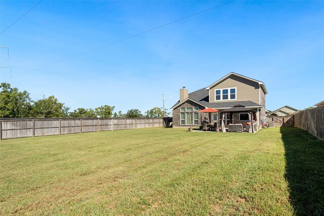 rear view of property featuring an outdoor hangout area and a lawn