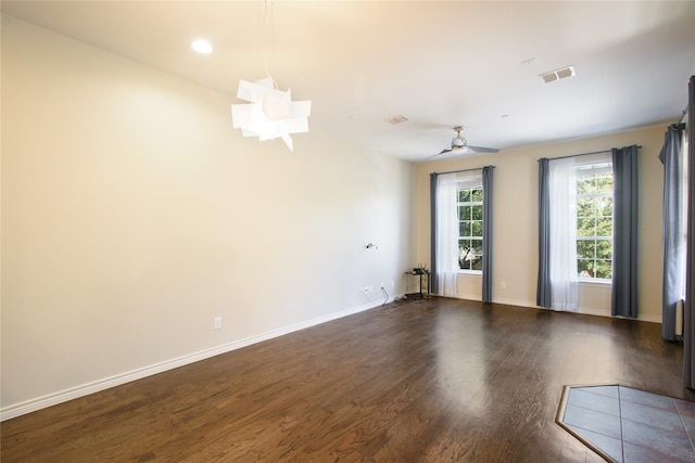 spare room with dark hardwood / wood-style floors and ceiling fan