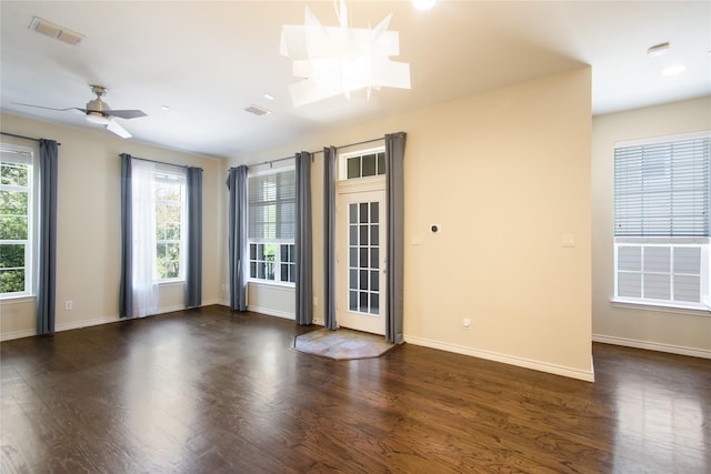 empty room with dark hardwood / wood-style floors and ceiling fan