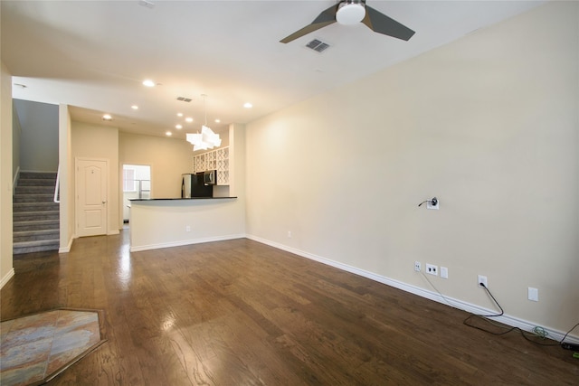 unfurnished living room with dark wood-type flooring and ceiling fan