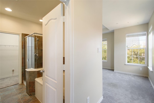 bathroom featuring independent shower and bath