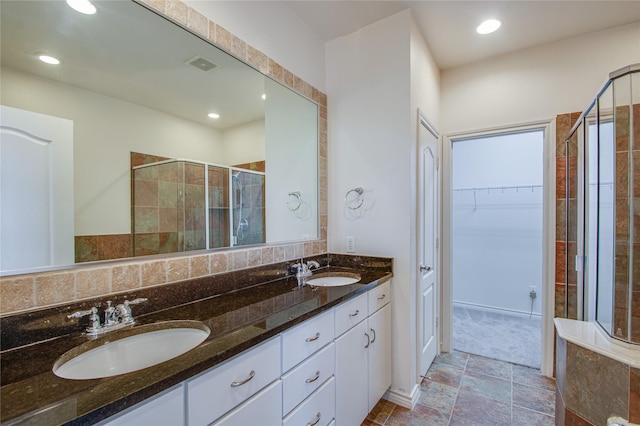 bathroom featuring an enclosed shower and vanity