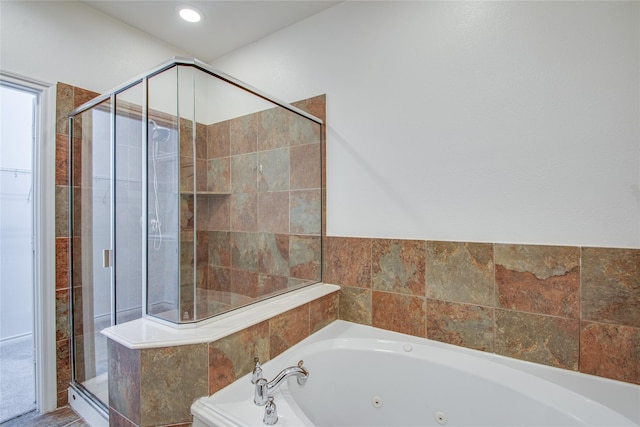 bathroom with separate shower and tub