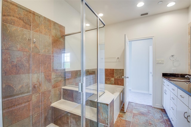 bathroom featuring vanity and shower with separate bathtub