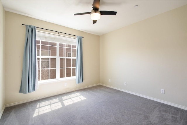 unfurnished room with ceiling fan and carpet flooring