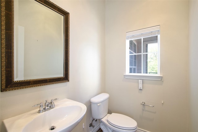 bathroom featuring toilet and sink