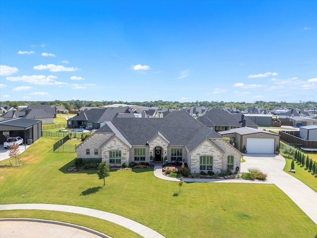 view of front of home with a front yard and a garage