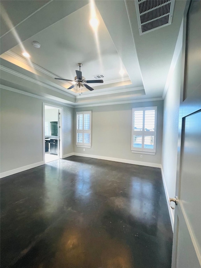 unfurnished room featuring a raised ceiling, ceiling fan, and ornamental molding