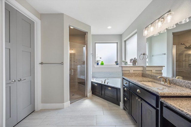 bathroom with vanity and independent shower and bath