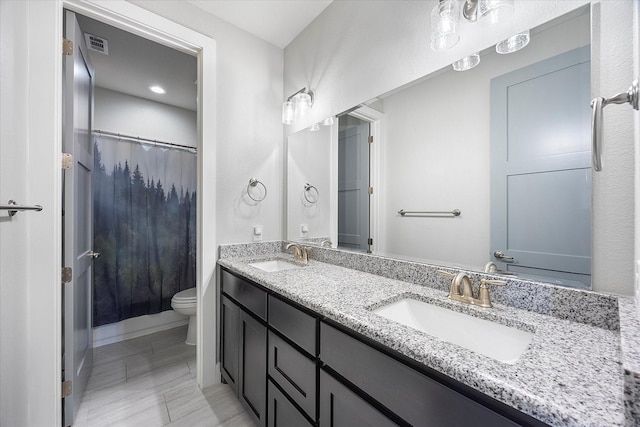 bathroom with tile patterned flooring, vanity, and toilet