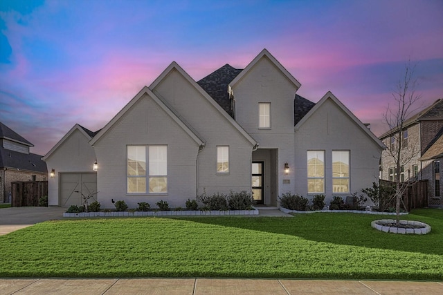 view of front of home with a yard and a garage