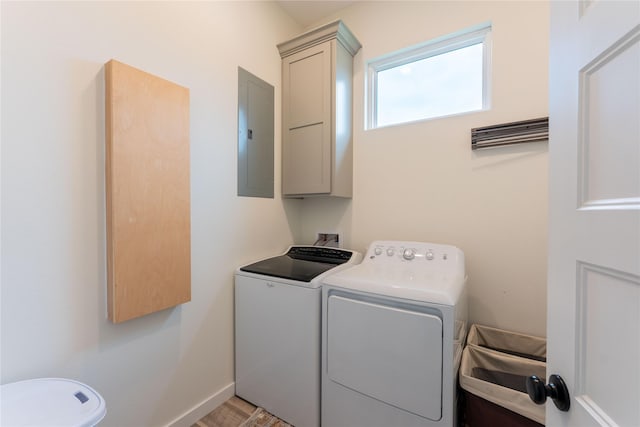 laundry area featuring cabinets, independent washer and dryer, light wood-type flooring, and electric panel