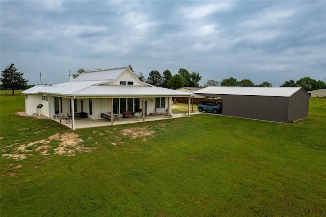 rear view of house featuring a yard and a patio