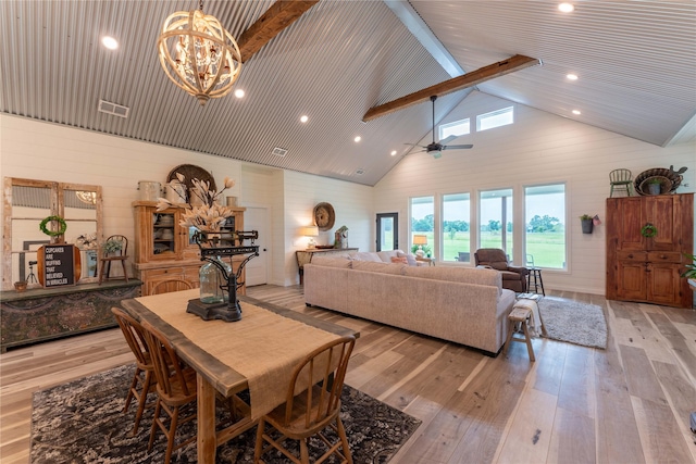 living room featuring wooden walls, light hardwood / wood-style flooring, and high vaulted ceiling