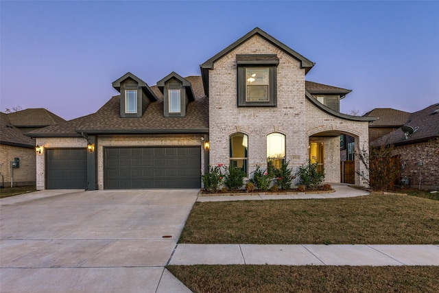 french country inspired facade featuring a yard