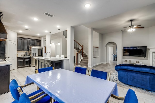 tiled dining area featuring sink and ceiling fan