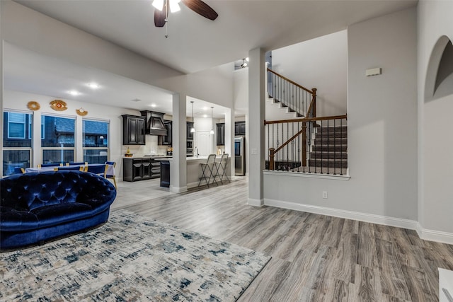 living room featuring ceiling fan and light hardwood / wood-style floors