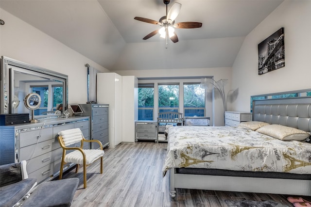 bedroom with vaulted ceiling, ceiling fan, and light hardwood / wood-style flooring