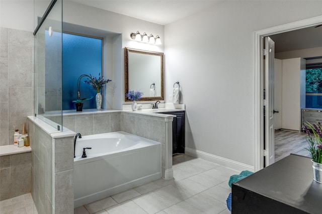 bathroom featuring vanity, shower with separate bathtub, and tile patterned flooring