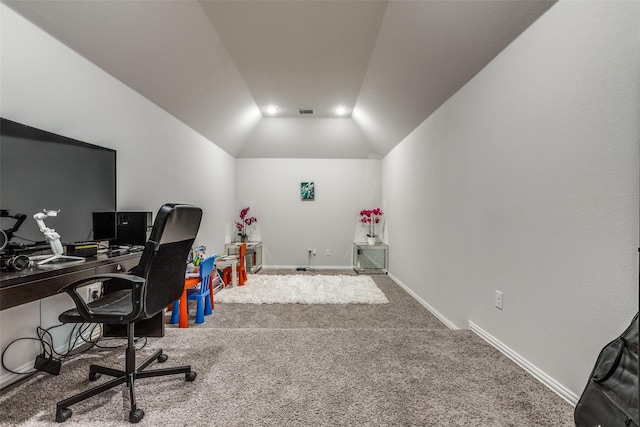 carpeted office space with vaulted ceiling