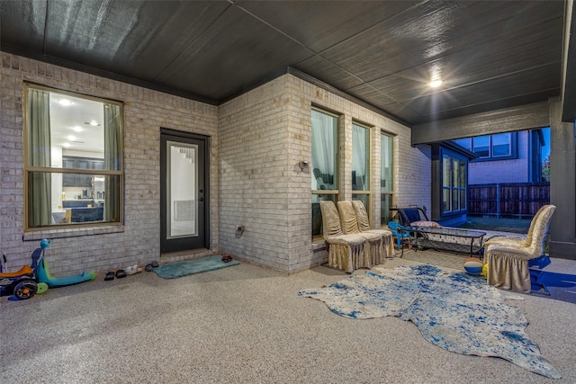 view of exterior entry featuring a patio area and outdoor lounge area