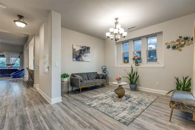 living room featuring light hardwood / wood-style floors and a notable chandelier