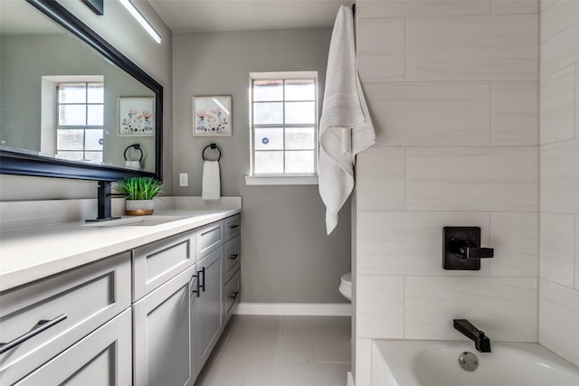 bathroom featuring tile patterned floors, plenty of natural light, toilet, and vanity