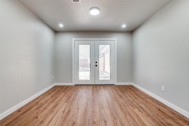 entryway with french doors and light hardwood / wood-style floors