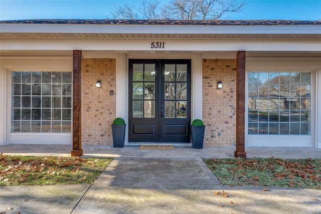 entrance to property with french doors and a porch