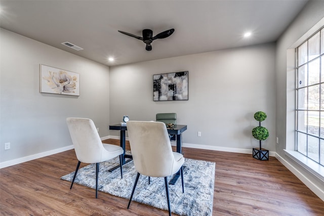 dining area with hardwood / wood-style flooring and ceiling fan