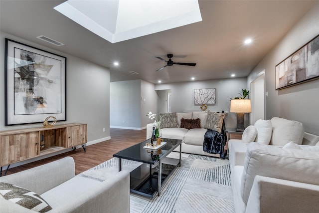 living room featuring wood-type flooring and ceiling fan