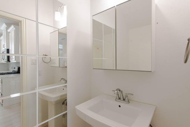 bathroom featuring sink and washer / dryer