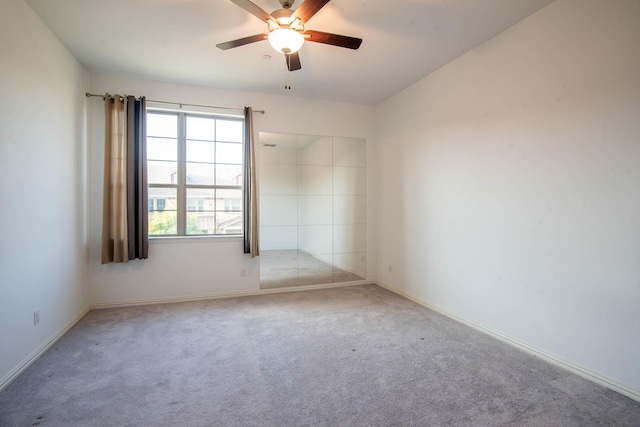 spare room featuring ceiling fan and carpet floors