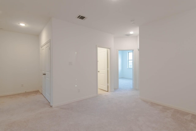 empty room featuring light colored carpet