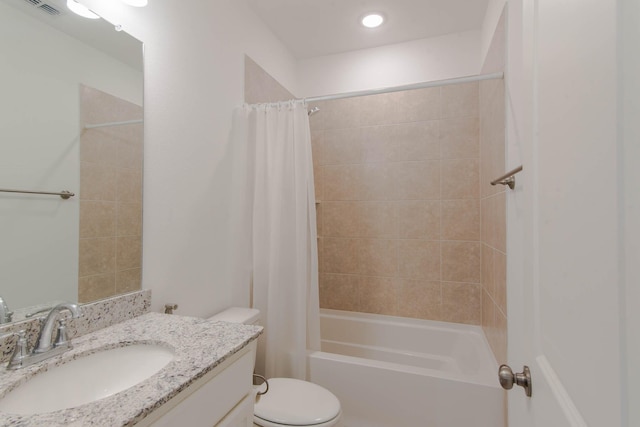 full bathroom with vanity, shower / tub combo, and toilet