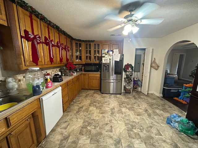 kitchen featuring stainless steel refrigerator with ice dispenser, a textured ceiling, white dishwasher, and ceiling fan